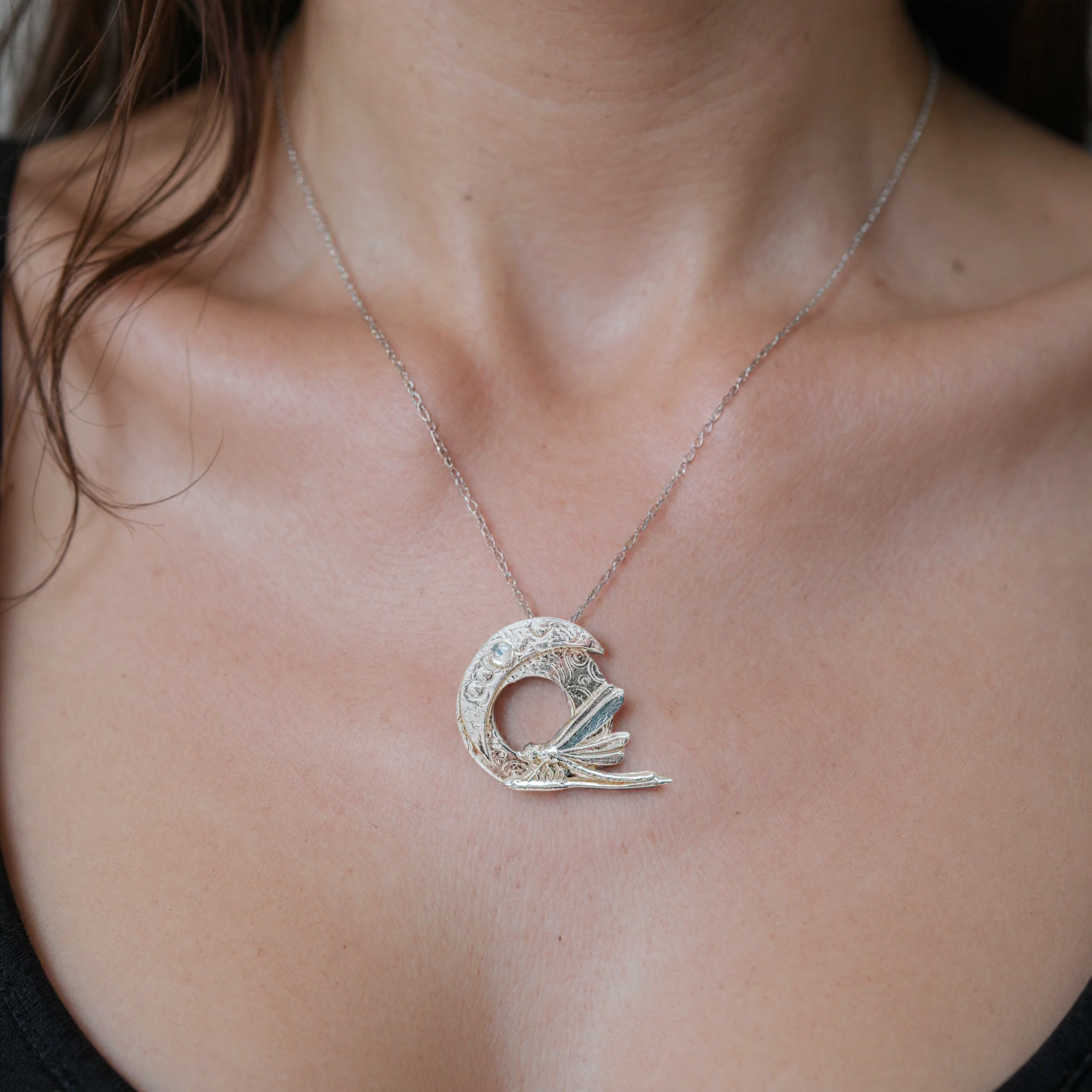 Dragonfly and moon silver pendant necklace shown on model, handmade unique silver jewellery UK