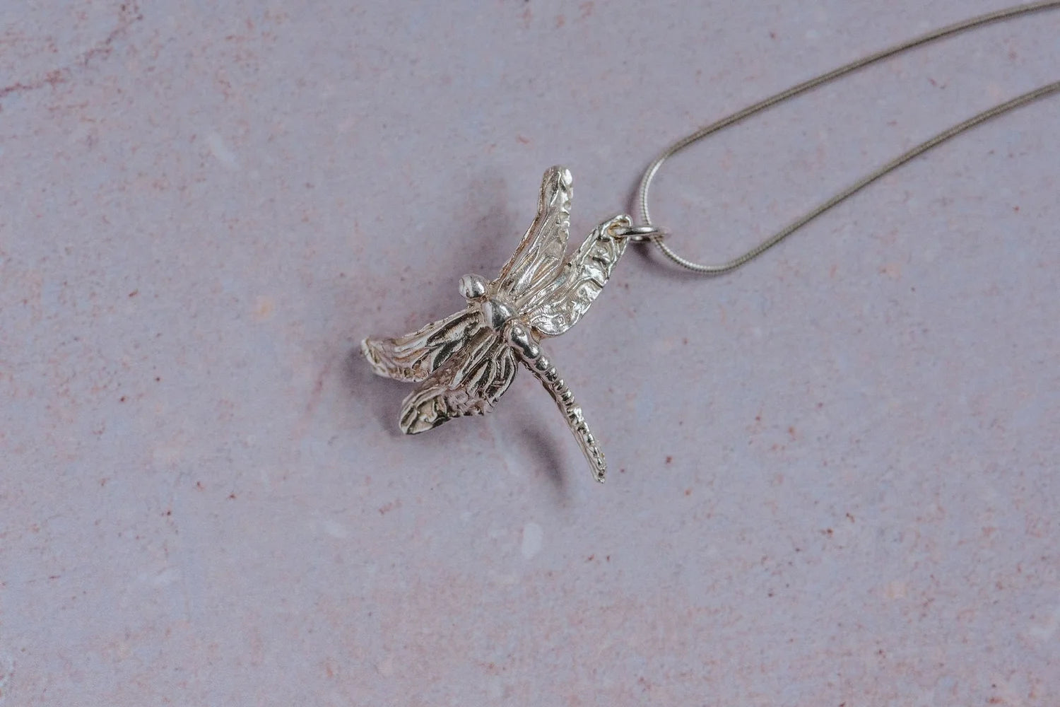 Handmade fine silver dragonfly pendant necklace with textured detailing on sterling silver chain