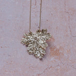 Handcrafted fine silver geranium leaf pendant necklace with intricate natural texture, inspired by Victorian floral symbolism of friendship and gentility.