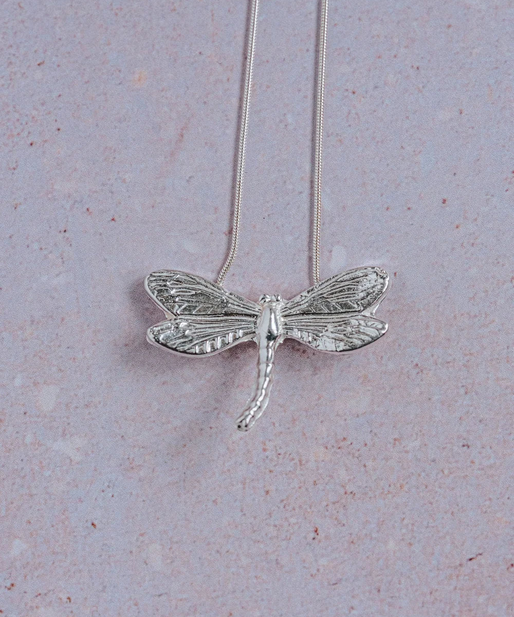 Handmade silver dragonfly pendant necklace with detailed textured wings on sterling silver snake chain