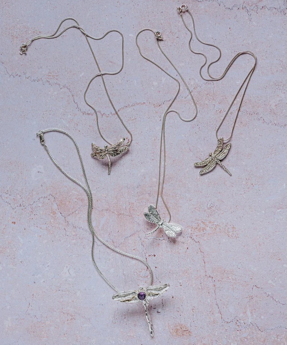 Collection of unique handmade silver dragonfly necklaces, including gemstone dragonfly pendant and detailed silver designs, artisan jewellery UK.