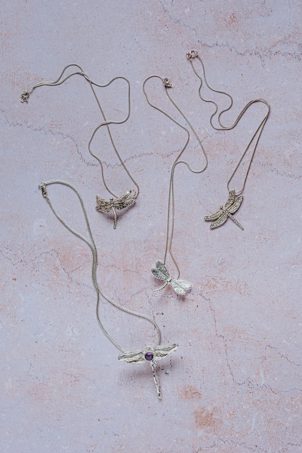 Collection of unique handmade silver dragonfly necklaces, including gemstone dragonfly pendant and detailed silver designs, artisan jewellery UK.