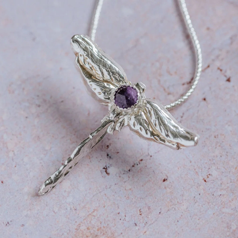 Handcrafted silver dragonfly pendant necklace with faceted amethyst gemstone, unique handmade silver jewellery inspired by nature.