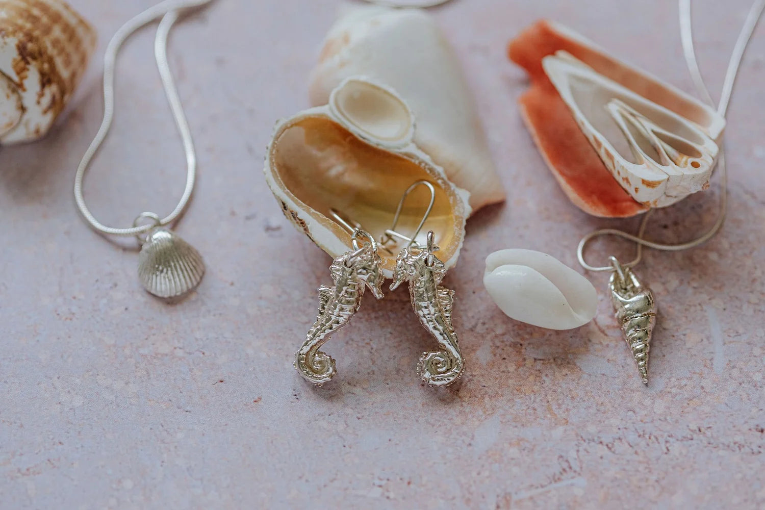 Handmade recycled silver mollusc shell pendant on 16-inch chain, styled with seahorse earrings and other shell jewellery