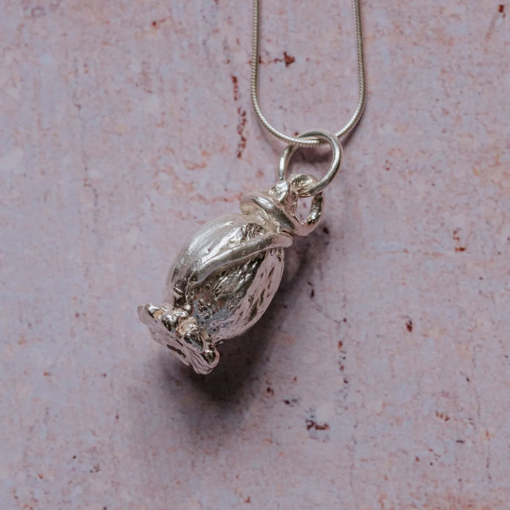Handmade fine silver poppy necklace with wrap-around bail on sterling silver snake chain, close up image
