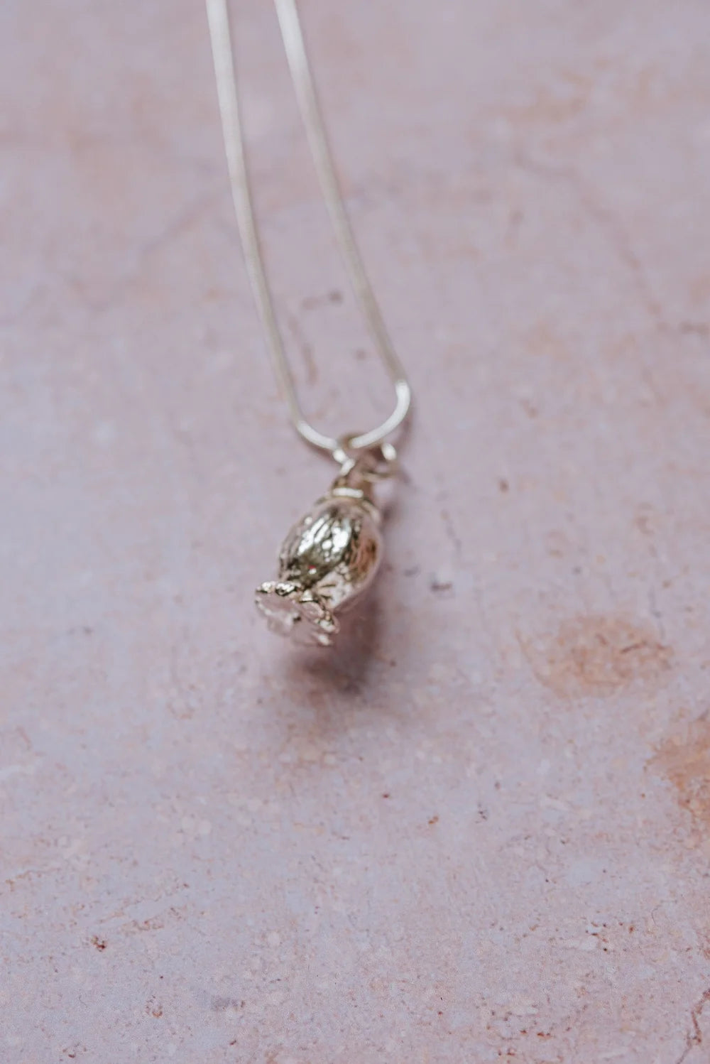 Handmade fine silver poppy seedhead pendant with wrap-around bail on sterling silver snake chain