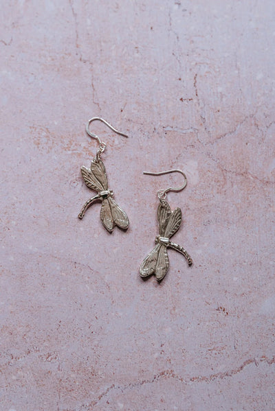 Handcrafted silver dragonfly dangle earrings, artisan nature-inspired jewellery made in the UK.