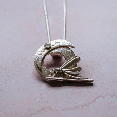 Art Nouveau inspired silver crescent moon and dragonfly pendant necklace with moonstone detail on sterling silver chain.