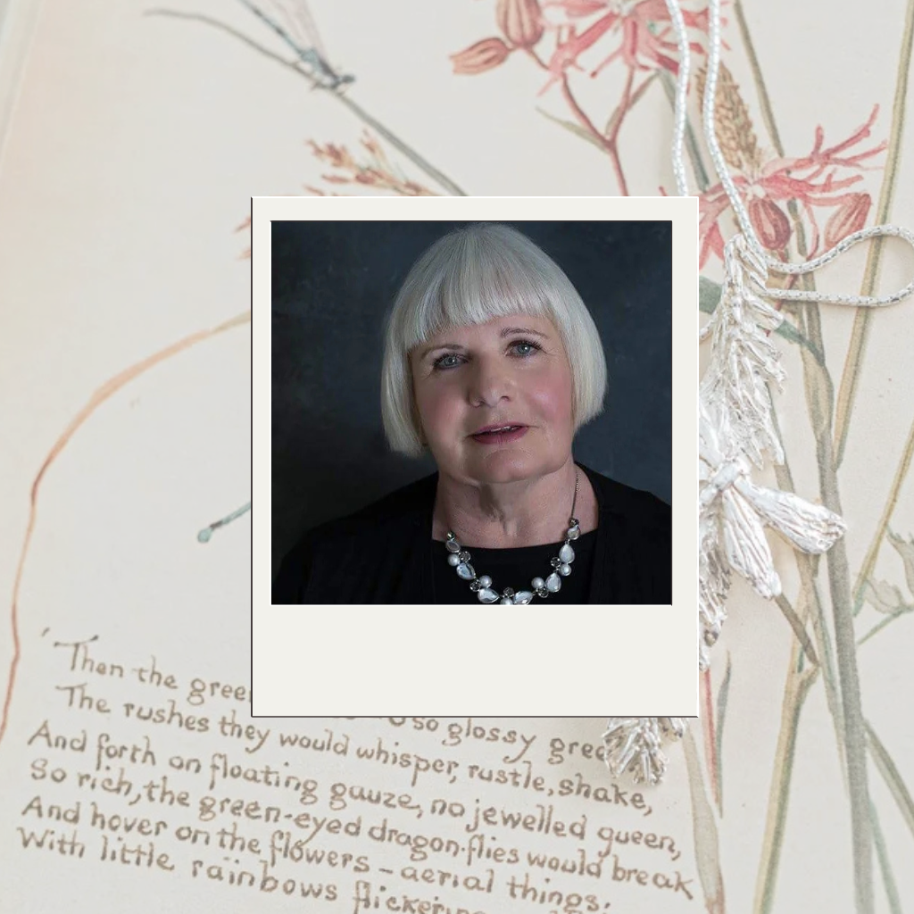 Portrait of Sue Studd, artisan silver jewellery maker and founder of The Magic of Fireflies and Dragonflies, wearing a handmade silver necklace.