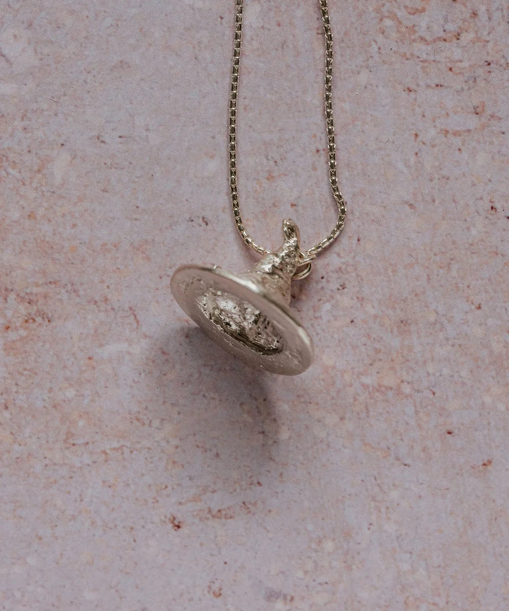 Handmade recycled silver witch hat pendant with tilted tip and floral detail on brim